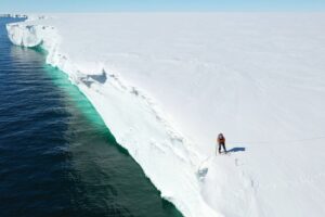 Bas-examining-ice-shelf-after-carving-antarctica